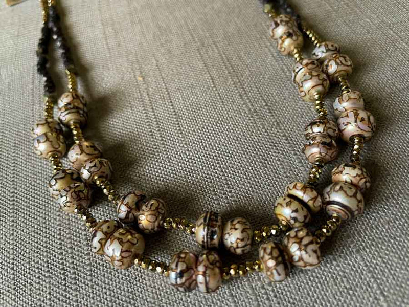 side view of gemstone bead necklace comprising neutral prayer beads, dark bronze and golden pyrite