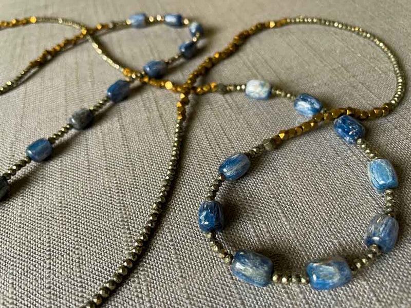 closeup of gemstone bead necklace comprising blue kyanite, bronze and dark grey pyrite