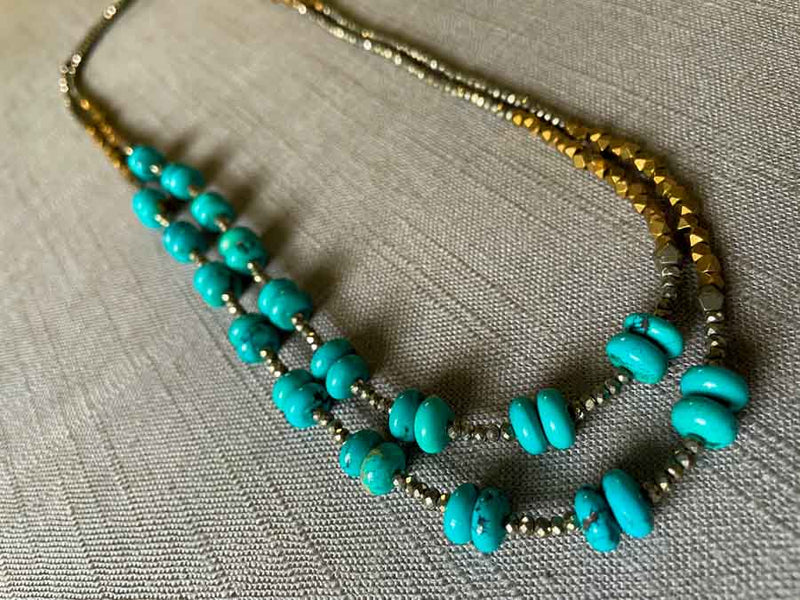 top view of gemstone bead necklace comprising turquoise, bronze and dark grey pyrite