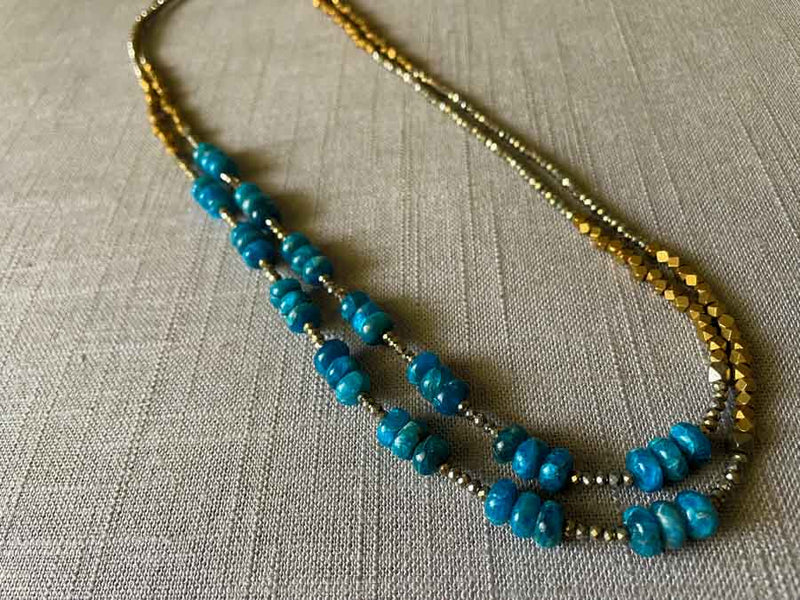 top view of gemstone bead necklace comprising blue apatite, bronze and dark grey pyrite