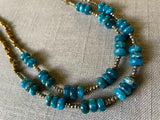 side view of gemstone bead necklace comprising blue apatite, bronze and dark grey pyrite