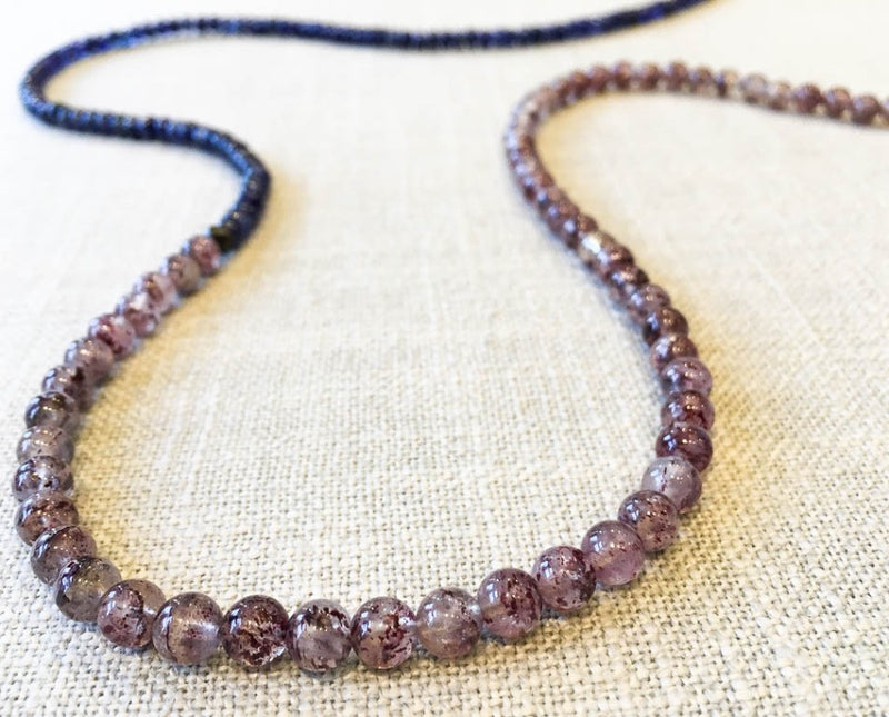 closeup of gemstone bead necklace comprising strawberry quartz, blue sapphire and matte bronze hematite