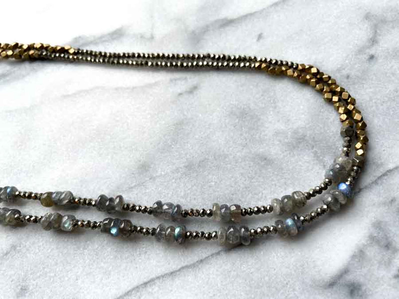 side view of gemstone bead necklace comprising labradorite, dark grey pyrite and bronze