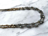 side view of gemstone bead necklace comprising labradorite, dark grey pyrite and bronze