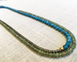 top view of gemstone bead necklace comprising green sapphire, aqua apatite and pyrite