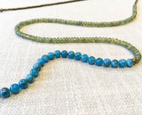 closeup of gemstone bead necklace comprising green sapphire, aqua apatite and pyrite