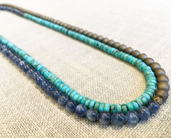 top view of gemstone bead necklace comprising blue kyanite, turquoise and bronze hematite