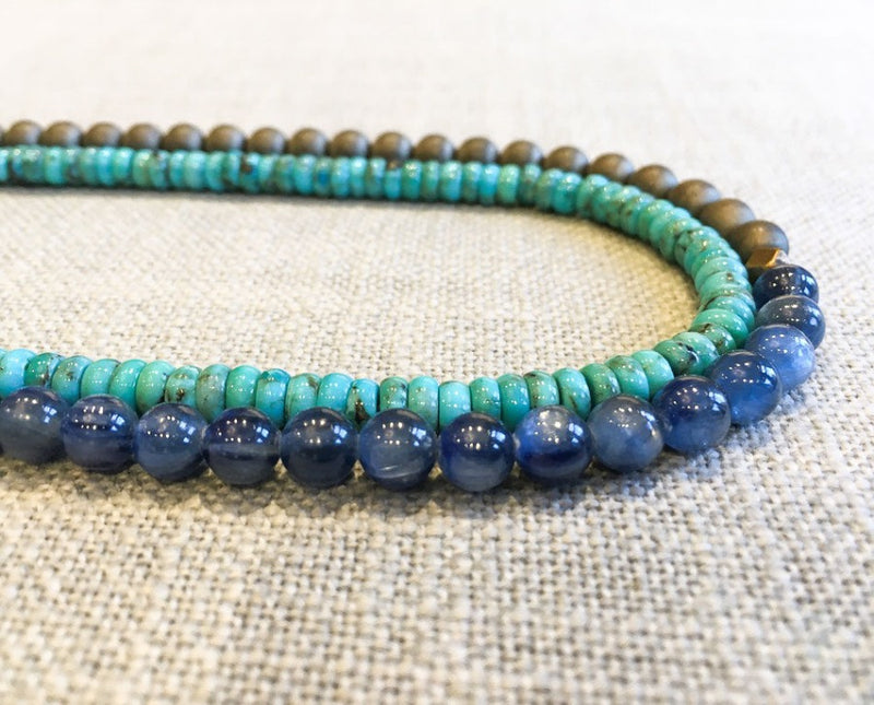 side view of gemstone bead necklace comprising blue kyanite, turquoise and matte bronze hematite