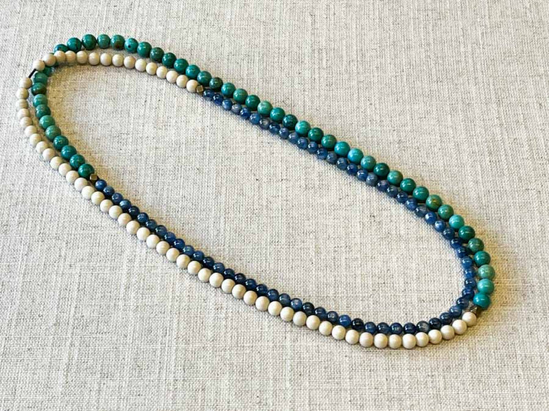 top view of gemstone bead necklace comprising bone, turquoise and blue kyanite