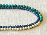 side view of gemstone bead necklace comprising bone, turquoise and blue kyanite