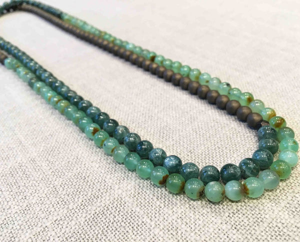 top view of gemstone bead necklace comprising blue kyanite, tea foam chrysoprase and bronze hematite