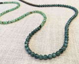 closeup of gemstone bead necklace comprising blue kyanite, chrysoprase and matte bronze hematite