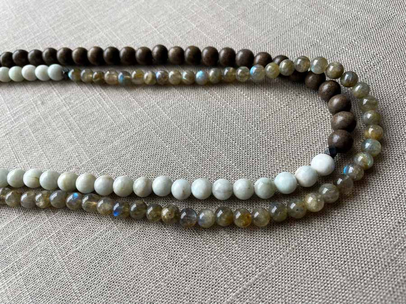 side view of gemstone bead necklace comprising white siberian moonstone, green labradorite and exotic wood