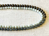 side view of gemstone bead necklace comprising tourmalated quartz, white moonstone and exotic wood