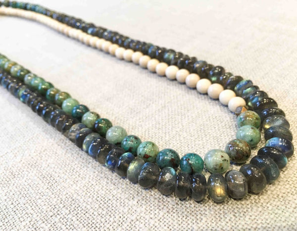 top view of gemstone bead necklace comprising off-white fossil jasper, green labradorite and green apatite