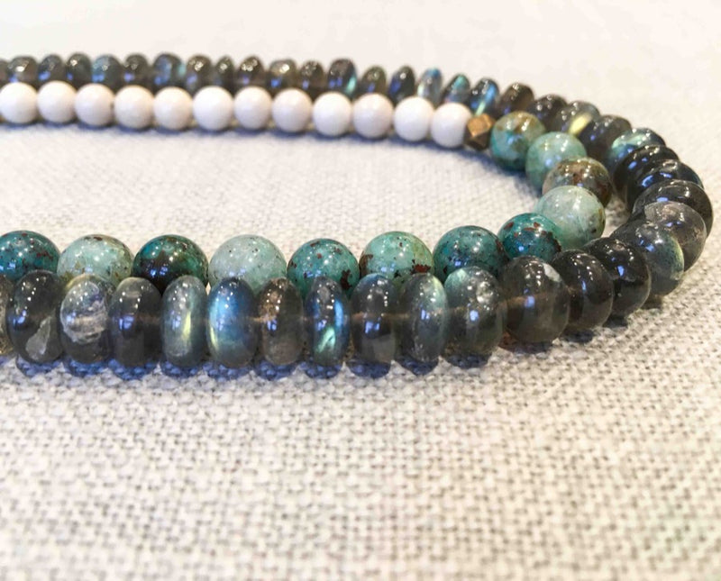 side view of gemstone bead necklace comprising off-white fossil jasper, green labradorite and green apatite