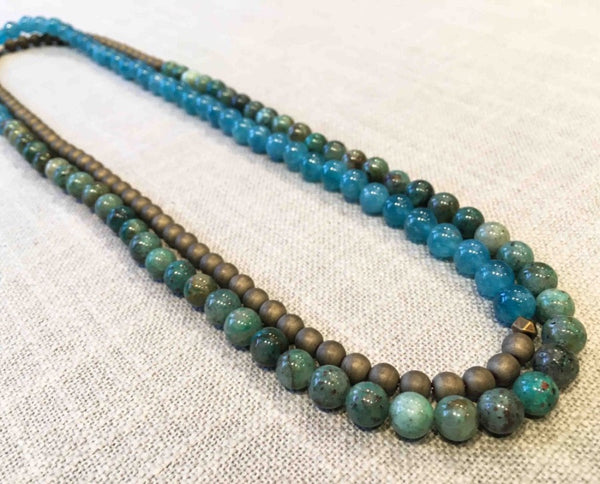 top view of gemstone bead necklace comprising green iolite, bronze hematite and aqua apatite