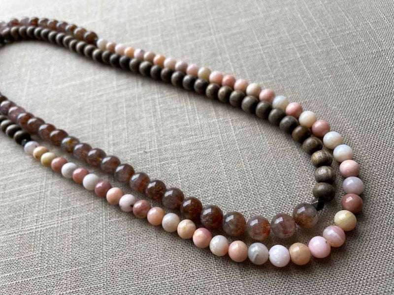 top view of gemstone bead necklace comprising strawberry quartz, pink opal and exotic wood