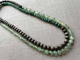 top view of gemstone bead necklace comprising green prehnite, teal aventurine and exotic wood