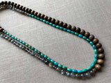 top view of gemstone bead necklace comprising blue labradorite, barrel turquoise and exotic wood