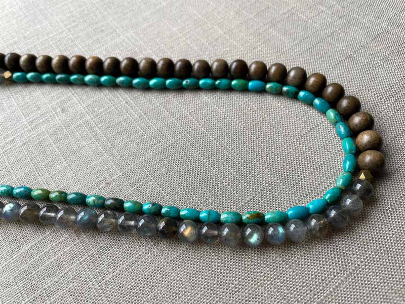 side view of gemstone bead necklace comprising blue labradorite, barrel turquoise and exotic wood