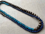 top view of gemstone bead necklace comprising blue apatite, dark blue lapis and exotic wood