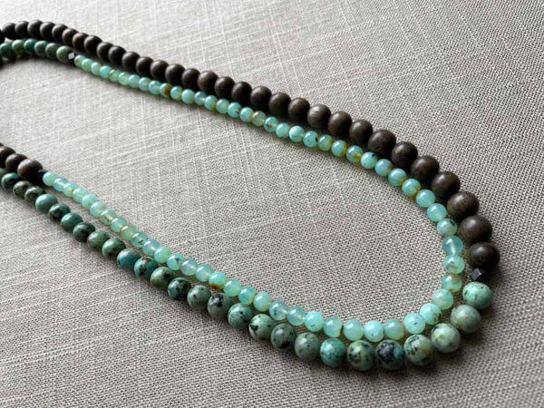 top view of gemstone bead necklace comprising blue chrysoprase and exotic wood