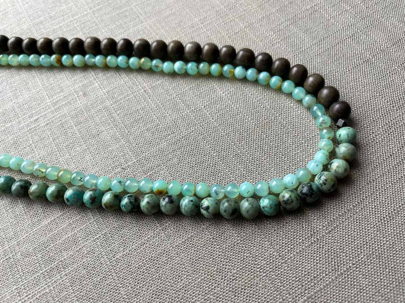 side view of gemstone bead necklace comprising blue chrysoprase and exotic wood