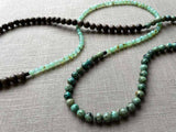 closeup of gemstone bead necklace comprising blue chrysoprase and exotic wood