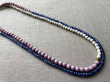 top view of gemstone bead necklace comprising purple phosphosiderite, blue sapphire and white turquoise