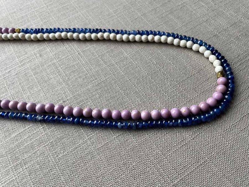 side view of gemstone bead necklace comprising purple phosphosiderite, blue sapphire and white turquoise