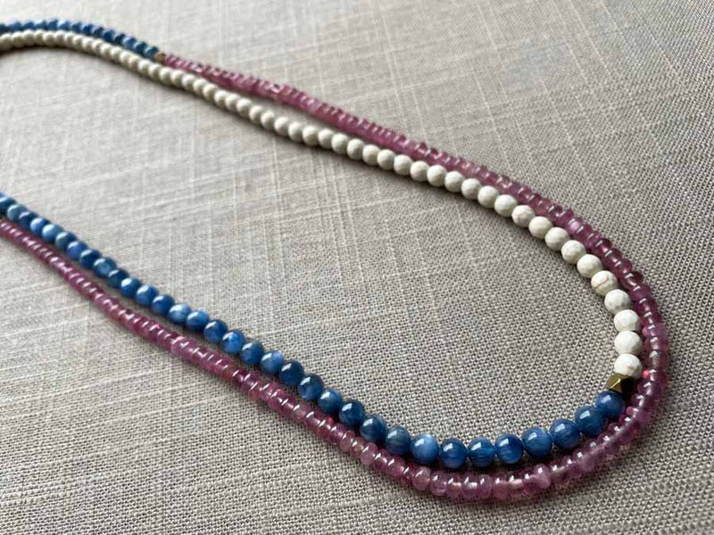 top view of gemstone bead necklace comprising blue kyanite, pink sapphire and white turquoise