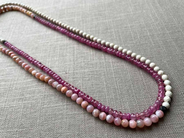 top view of gemstone bead necklace comprising pink opal, pink sapphire and white turquoise