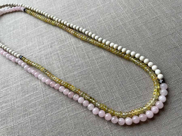 top view of gemstone bead necklace comprising pink rose quartz, yellow sapphire and white turquoise