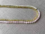 side view of gemstone bead necklace comprising pink rose quartz, yellow sapphire and white turquoise