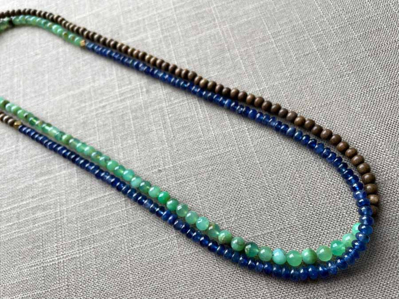 top view of gemstone bead necklace comprising sea foam chrysoprase, blue sapphire and exotic wood