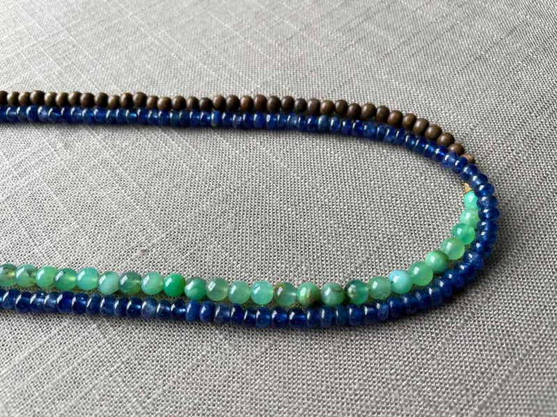 side view of gemstone bead necklace comprising sea foam chrysoprase, blue sapphire and exotic wood