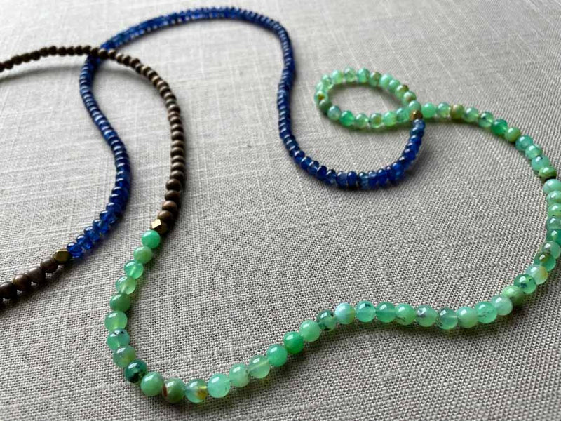 closeup of gemstone bead necklace comprising sea foam chrysoprase, blue sapphire and exotic wood