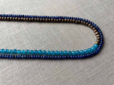 side view of gemstone bead necklace comprising blue apatite, blue sapphire and exotic wood