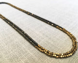 top view of gemstone bead necklace comprising of dark grey pyrite and bronze