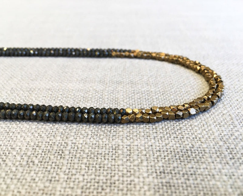 side view of gemstone bead necklace comprising pyrite and bronze