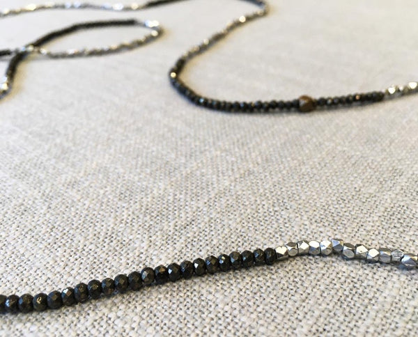 closeup of gemstone bead necklace comprising pyrite and silver-plate on bronze