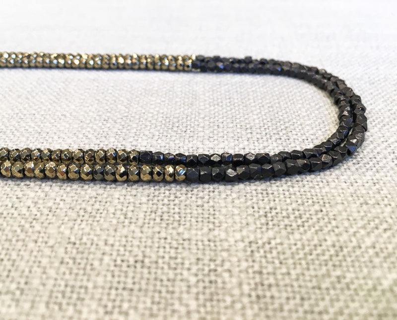 side view of gemstone bead necklace comprising golden pyrite and dark bronze