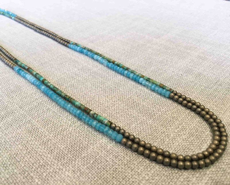 top view of gemstone bead necklace comprising blue chalcedony, light gold hematite and turquoise