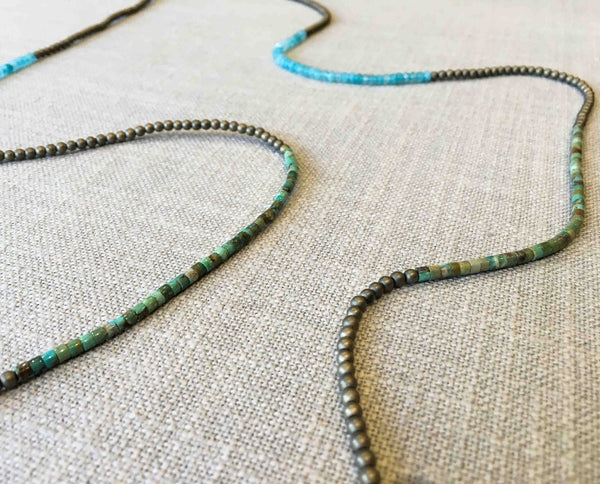 closeup of gemstone bead necklace comprising blue chalcedony, light gold hematite and turquoise