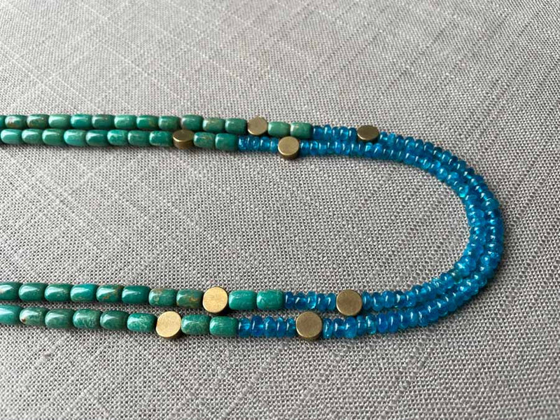 side view of gemstone bead necklace comprising turquoise, blue iolite and bronze dot accents