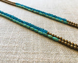 side view of gemstone bead necklace comprising aqua apatite, gold hematite and turquoise