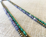 side view of gemstone bead necklace comprising blue denim quartz, light gold hematite and turquoise