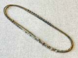  top view of gemstone bead necklace comprising shell, moonstone, pyrite and hematite