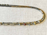 side view of gemstone bead necklace comprising shell, moonstone, pyrite and hematite